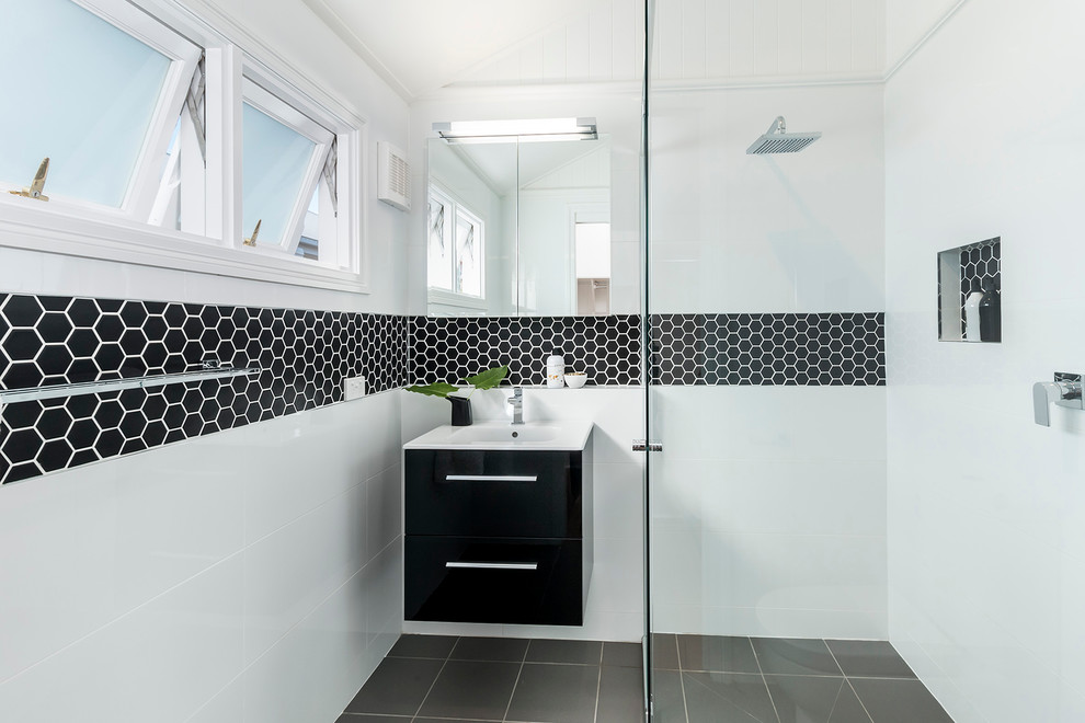 Example of a small trendy 3/4 black and white tile ceramic tile walk-in shower design in Brisbane with flat-panel cabinets, black cabinets and white walls