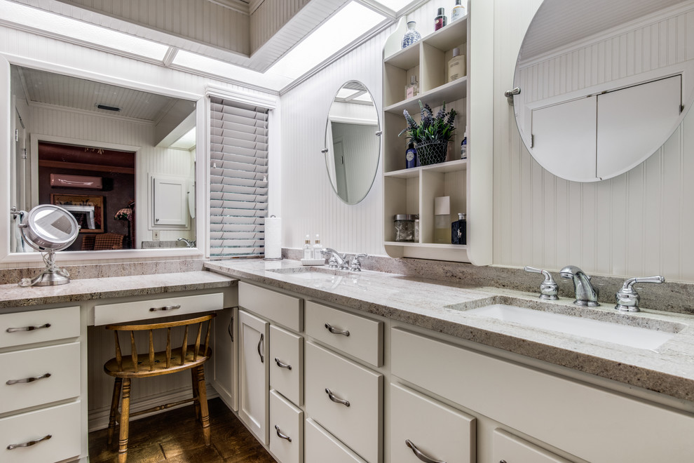 Medium sized classic ensuite bathroom in Austin with flat-panel cabinets, white cabinets, an alcove shower, a two-piece toilet, white tiles, ceramic tiles, white walls, ceramic flooring, a built-in sink, engineered stone worktops, brown floors, an open shower and beige worktops.