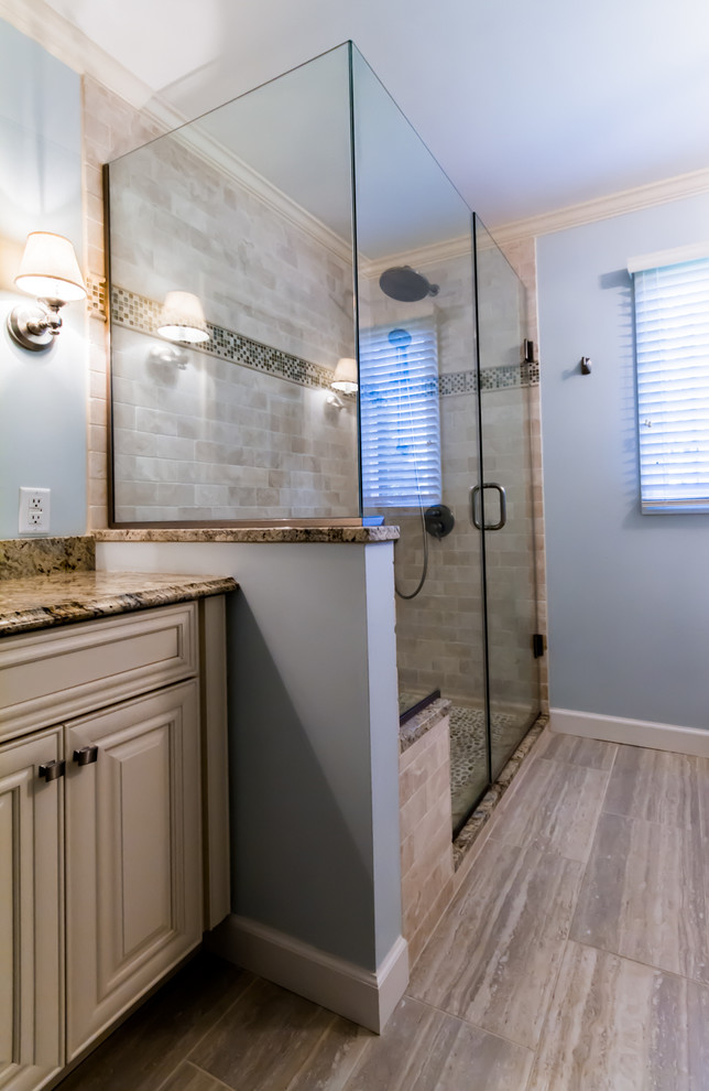 Mid-sized beach style master beige tile and ceramic tile porcelain tile and beige floor bathroom photo in St Louis with raised-panel cabinets, white cabinets, blue walls, an undermount sink, granite countertops and a hinged shower door
