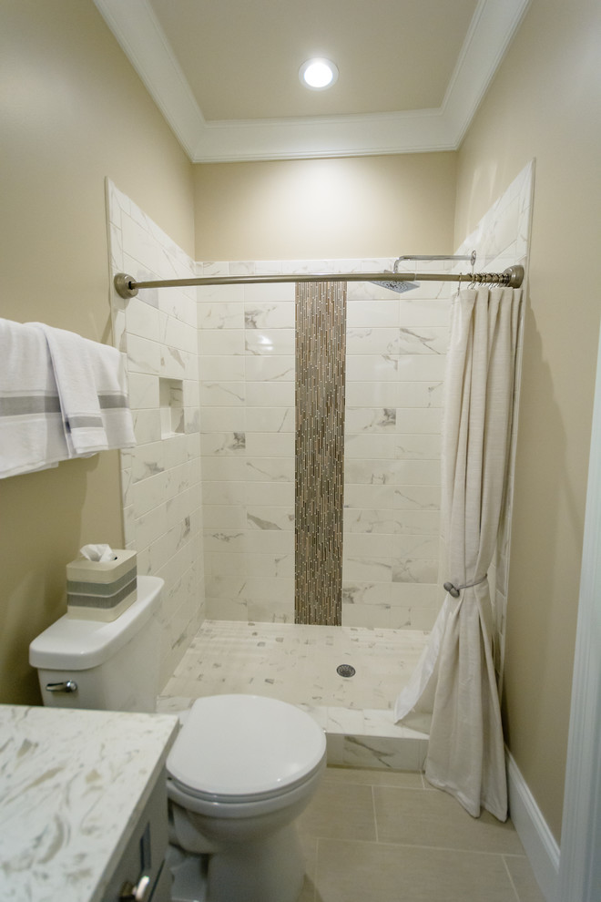 Mid-sized elegant 3/4 beige tile, white tile and marble tile porcelain tile and beige floor bathroom photo in Raleigh with recessed-panel cabinets, gray cabinets, a two-piece toilet, beige walls, an undermount sink, granite countertops and white countertops