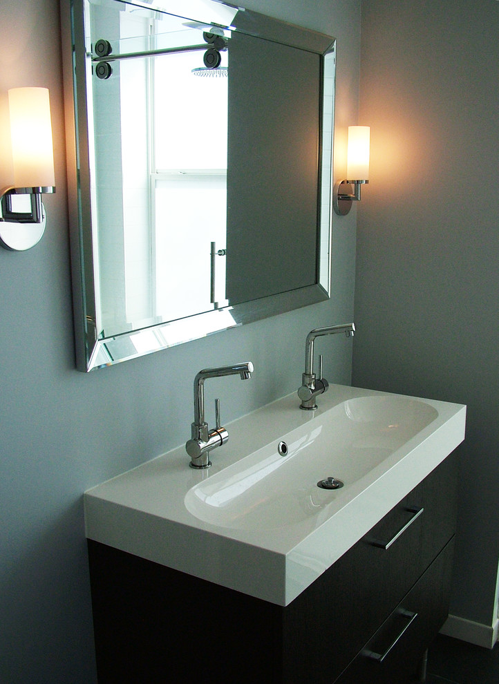 Bathroom - mid-sized contemporary 3/4 ceramic tile and black tile ceramic tile bathroom idea in Montreal with flat-panel cabinets, solid surface countertops, blue walls, black cabinets, a two-piece toilet and an integrated sink