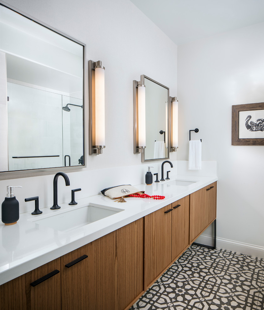 Medium sized classic ensuite bathroom in San Francisco with freestanding cabinets, brown cabinets, a two-piece toilet, white tiles, white walls, cement flooring, a submerged sink, engineered stone worktops and a hinged door.
