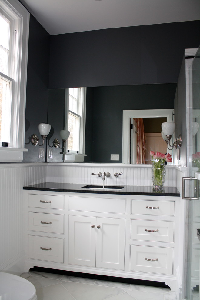 Medium sized traditional bathroom in Charlotte with a submerged sink, beaded cabinets, white cabinets, granite worktops, a walk-in shower, white tiles, stone slabs, black walls and marble flooring.