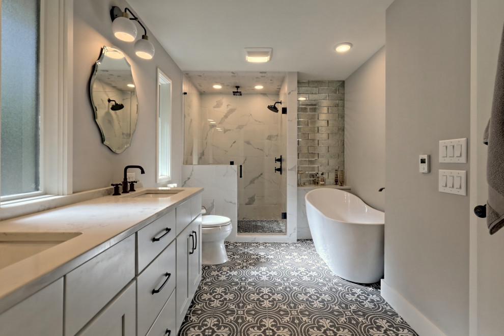 Example of a mid-sized cottage master white tile ceramic tile and gray floor bathroom design in Atlanta with shaker cabinets, white cabinets, a one-piece toilet, an undermount sink, quartz countertops and white countertops