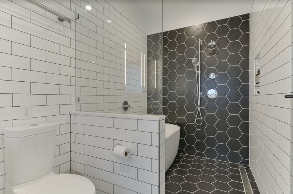This is an example of a medium sized modern ensuite wet room bathroom in Portland with white cabinets, a freestanding bath, a two-piece toilet, white tiles, metro tiles, white walls, porcelain flooring, a submerged sink, engineered stone worktops, black floors, a hinged door and white worktops.