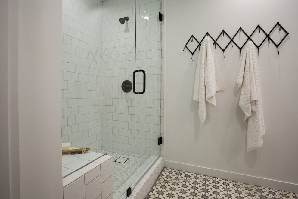 Inspiration for a mid-sized country master white tile and ceramic tile cement tile floor and gray floor bathroom remodel in Los Angeles with louvered cabinets, gray cabinets, a one-piece toilet, white walls, an undermount sink, marble countertops and a hinged shower door