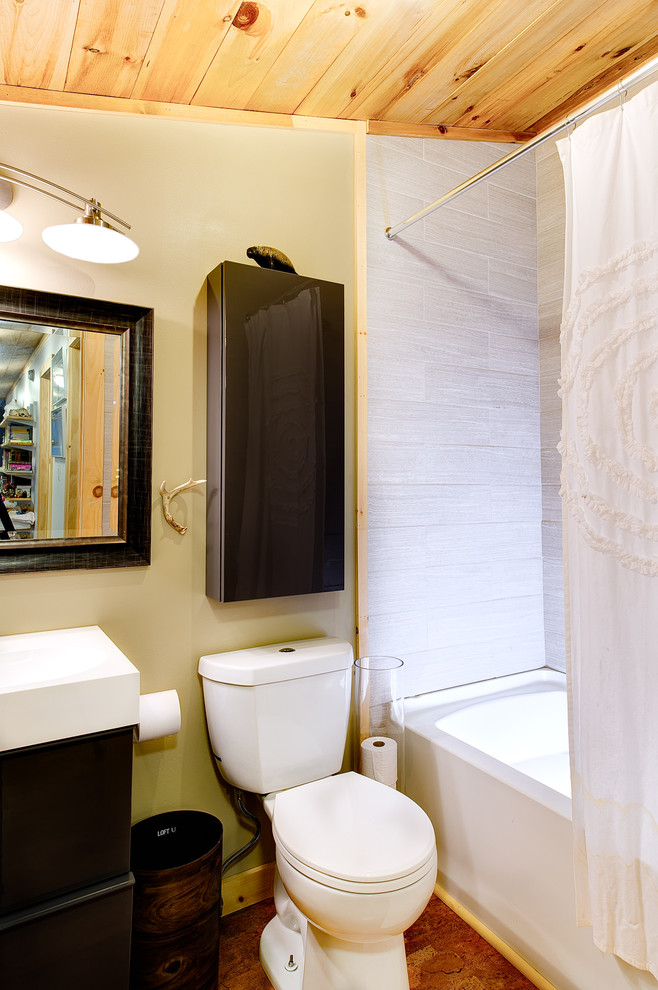 Photo of a large rustic family bathroom in Burlington with flat-panel cabinets, brown cabinets, a corner bath, a shower/bath combination, a one-piece toilet, white tiles, ceramic tiles, beige walls, bamboo flooring, a wall-mounted sink, recycled glass worktops and brown floors.