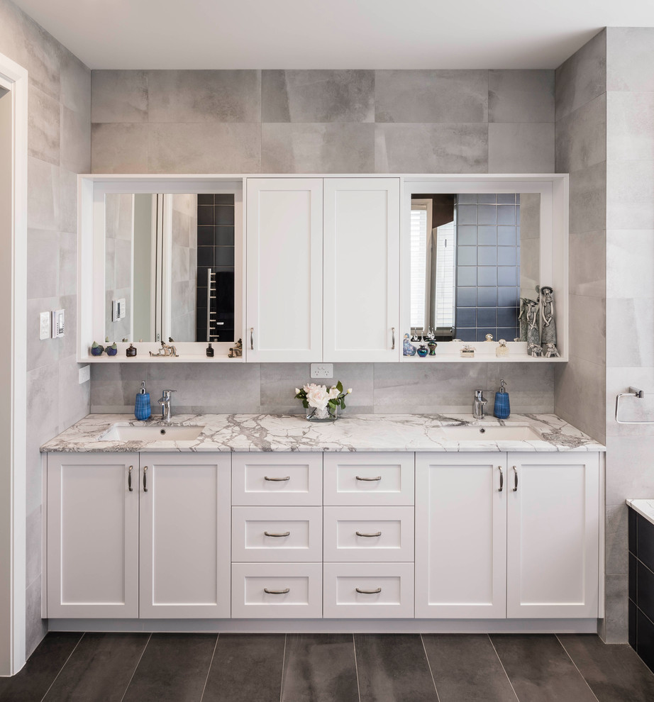 Inspiration for a large contemporary ensuite bathroom in Sydney with shaker cabinets, white cabinets, a built-in bath, a double shower, grey tiles, ceramic tiles, grey walls, ceramic flooring, a submerged sink, granite worktops, brown floors, an open shower and multi-coloured worktops.