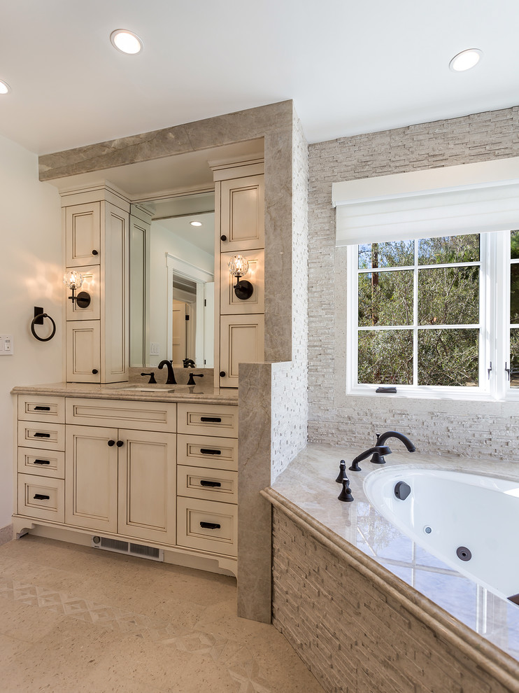 Mid-sized trendy master gray tile and stone tile marble floor and gray floor bathroom photo in Los Angeles with shaker cabinets, distressed cabinets, a one-piece toilet, beige walls, an undermount sink, quartzite countertops and a hinged shower door