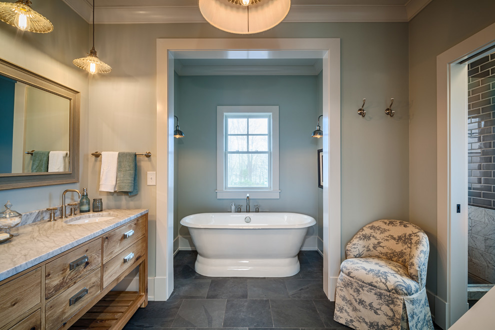 Idéer för att renovera ett mellanstort lantligt en-suite badrum, med släta luckor, skåp i mellenmörkt trä, ett fristående badkar, grå kakel, vit kakel, porslinskakel, grå väggar, skiffergolv, ett undermonterad handfat, marmorbänkskiva och grått golv