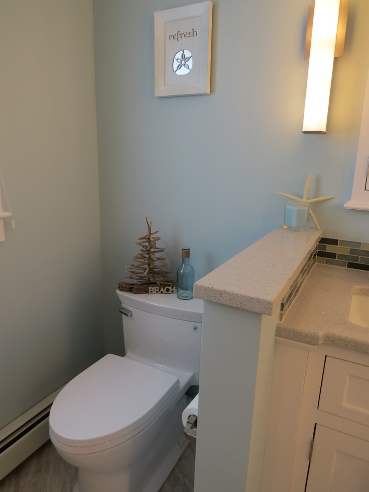 Example of a mid-sized beach style master multicolored tile and glass tile porcelain tile walk-in shower design in Portland Maine with an undermount sink, beaded inset cabinets, white cabinets, quartz countertops, a two-piece toilet and blue walls
