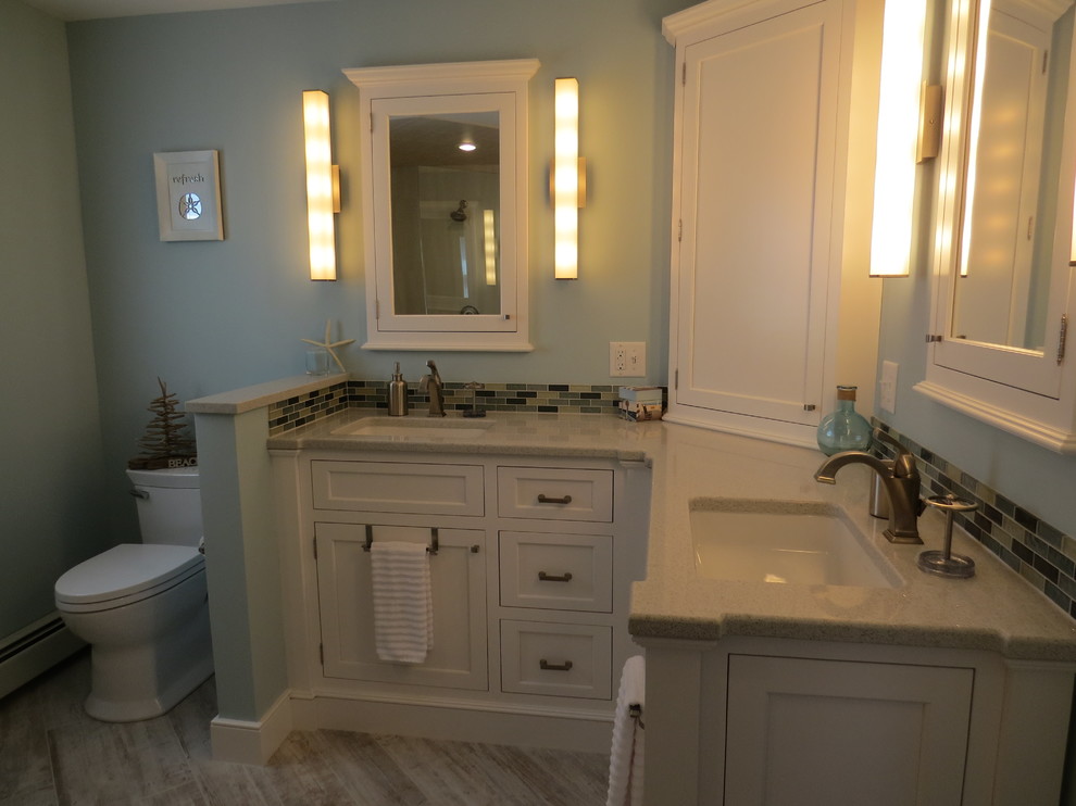 Inspiration for a mid-sized coastal master multicolored tile and glass tile porcelain tile walk-in shower remodel in Portland Maine with an undermount sink, beaded inset cabinets, white cabinets, quartz countertops, a two-piece toilet and blue walls