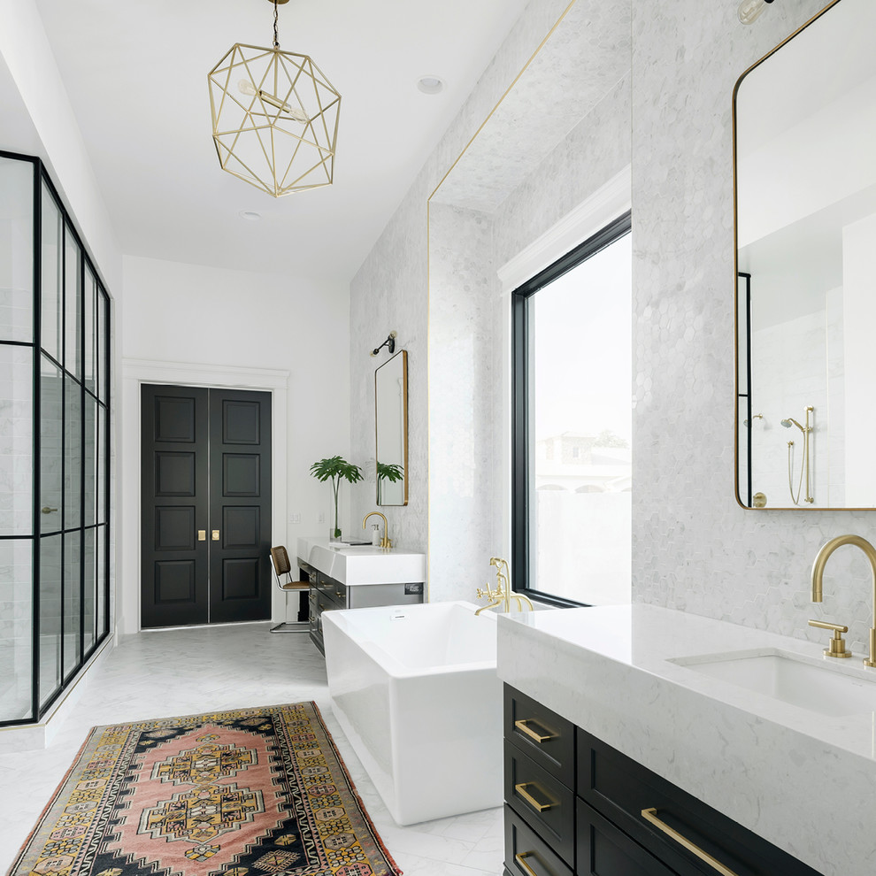 На фото: главная ванная комната в стиле неоклассика (современная классика) с фасадами с утопленной филенкой, черными фасадами, отдельно стоящей ванной, угловым душем, белыми стенами, врезной раковиной и белым полом с