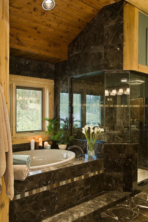 Photo of a large rustic ensuite bathroom in Other with a built-in bath, an alcove shower, black tiles, marble tiles, black walls, marble flooring, black floors and a hinged door.