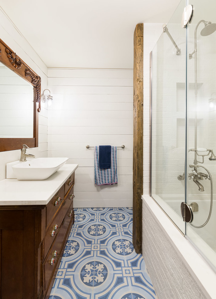 Idées déco pour une salle de bain principale montagne en bois foncé de taille moyenne avec une baignoire encastrée, un combiné douche/baignoire, un carrelage blanc, des carreaux de porcelaine, un mur blanc, un sol en carrelage de porcelaine, une vasque, un plan de toilette en quartz modifié, un sol bleu, une cabine de douche à porte battante, un plan de toilette blanc et un placard à porte plane.
