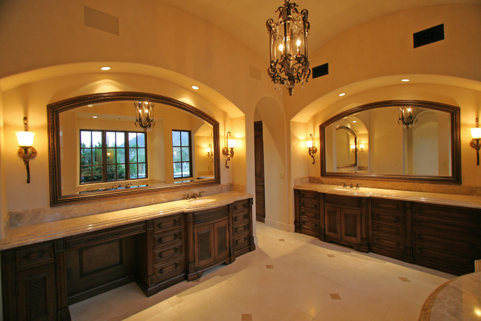 Double shower - huge mediterranean master beige tile and stone tile travertine floor double shower idea in Phoenix with flat-panel cabinets, light wood cabinets, a hot tub, a one-piece toilet, beige walls, an integrated sink and tile countertops