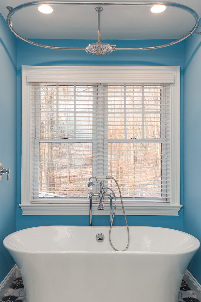 Foto de cuarto de baño infantil actual de tamaño medio con armarios con paneles empotrados, puertas de armario de madera en tonos medios, bañera exenta, combinación de ducha y bañera, sanitario de una pieza, paredes azules, suelo de baldosas de cerámica, lavabo de seno grande, encimera de mármol, suelo multicolor, ducha con cortina y encimeras grises