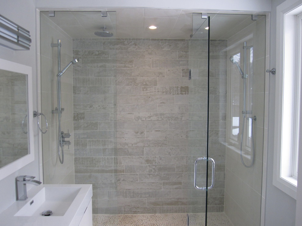 Classic ensuite bathroom in Toronto with an integrated sink, white cabinets, a double shower, a one-piece toilet, white tiles, porcelain tiles and porcelain flooring.