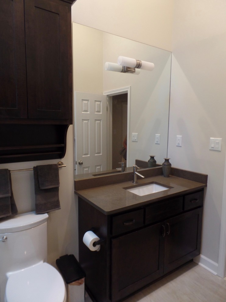 Inspiration for a medium sized classic family bathroom in Other with shaker cabinets, dark wood cabinets, an alcove bath, a shower/bath combination, a one-piece toilet, beige tiles, porcelain tiles, beige walls, porcelain flooring, a submerged sink, engineered stone worktops, beige floors and a sliding door.