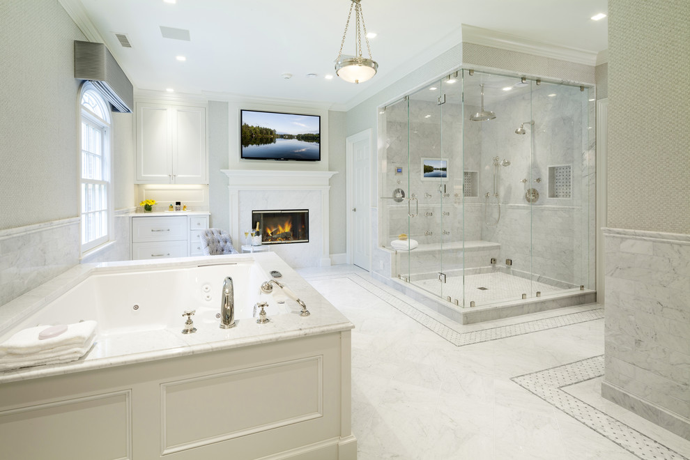 Example of a large transitional master white tile and stone tile marble floor and white floor bathroom design in Other with furniture-like cabinets, white cabinets, beige walls, an integrated sink, marble countertops and a hinged shower door