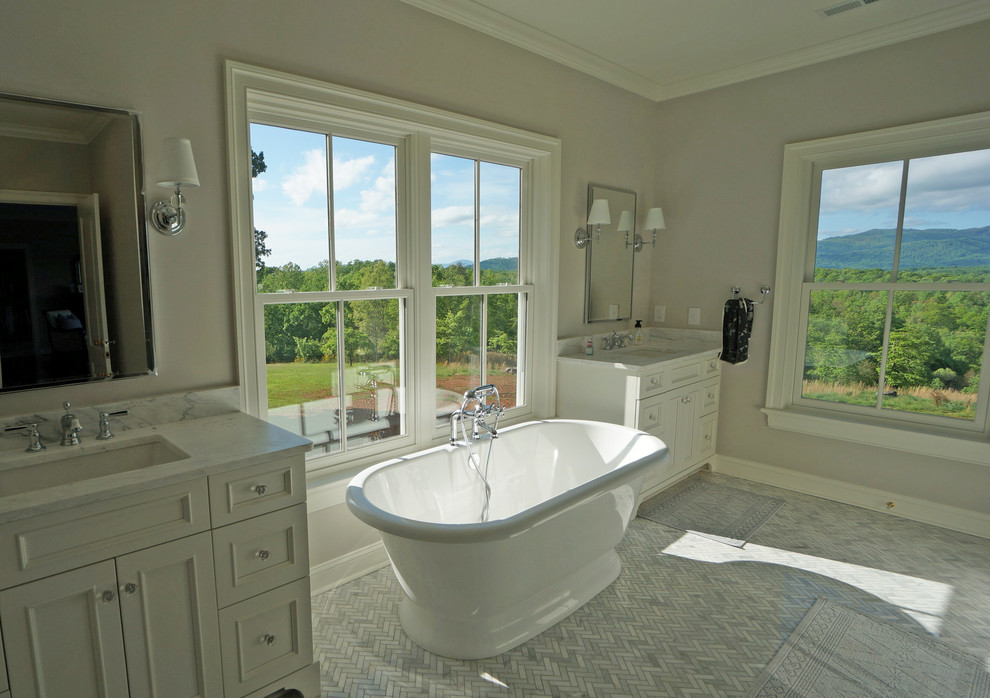 Inspiration for a large country ensuite bathroom in Other with recessed-panel cabinets, white cabinets, a freestanding bath, grey walls, marble flooring, a submerged sink, marble worktops, grey floors and grey worktops.