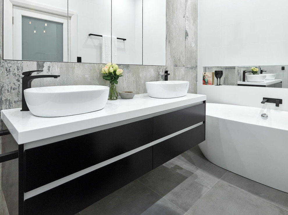 Inspiration for a small urban bathroom in Adelaide with black cabinets, a freestanding bath, a walk-in shower, a wall mounted toilet, porcelain tiles, porcelain flooring and a vessel sink.