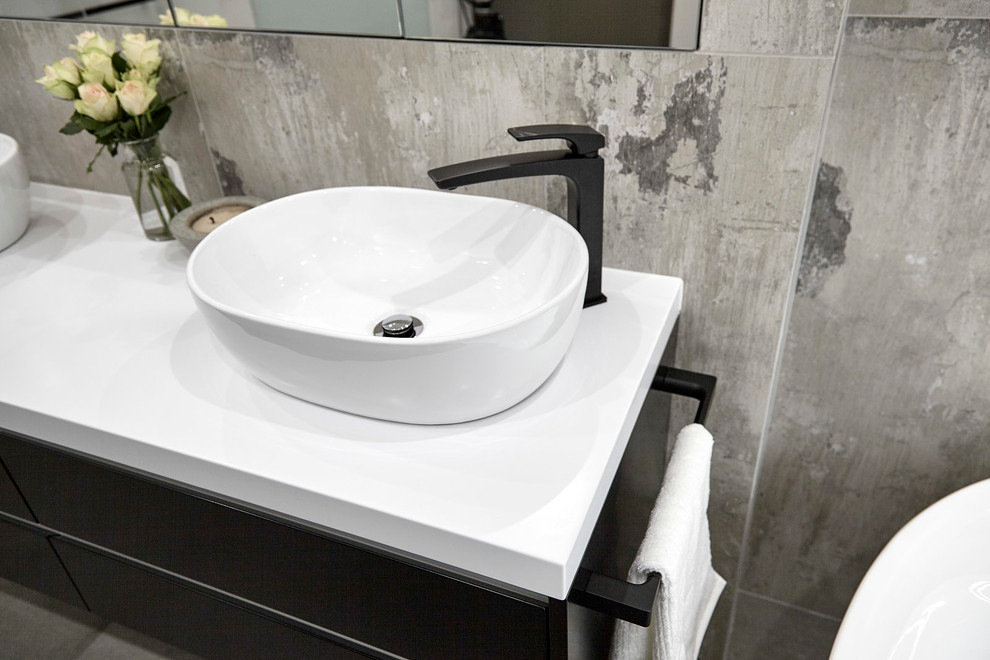 Bathroom - small industrial porcelain tile porcelain tile bathroom idea in Adelaide with black cabinets, a wall-mount toilet and a vessel sink