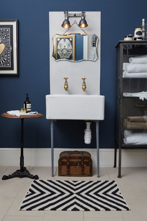 Eclectic Charm: Blue Bathroom Ideas Featuring a Vintage Sink and Brass Faucets
