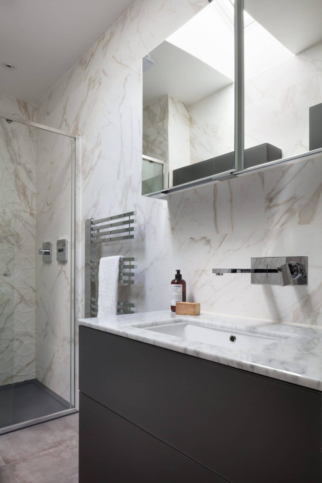Small contemporary ensuite bathroom in London with flat-panel cabinets, grey cabinets, white tiles, ceramic tiles, white walls, cement flooring, a submerged sink, marble worktops, grey floors, a hinged door, grey worktops, a double shower and a wall mounted toilet.