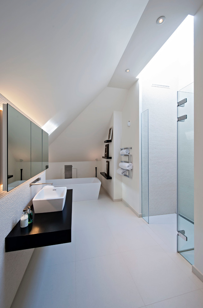 Modernes Badezimmer mit freistehender Badewanne, weißer Wandfarbe und Aufsatzwaschbecken in London