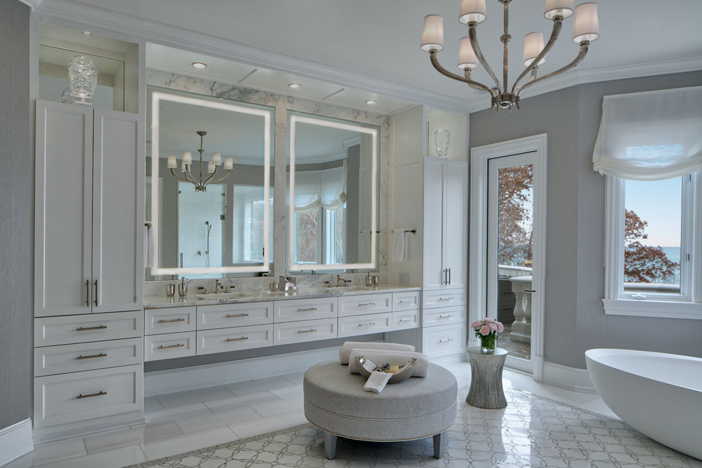Photo of a classic ensuite bathroom in Chicago with shaker cabinets, white cabinets, a freestanding bath, grey walls, a submerged sink and multi-coloured floors.