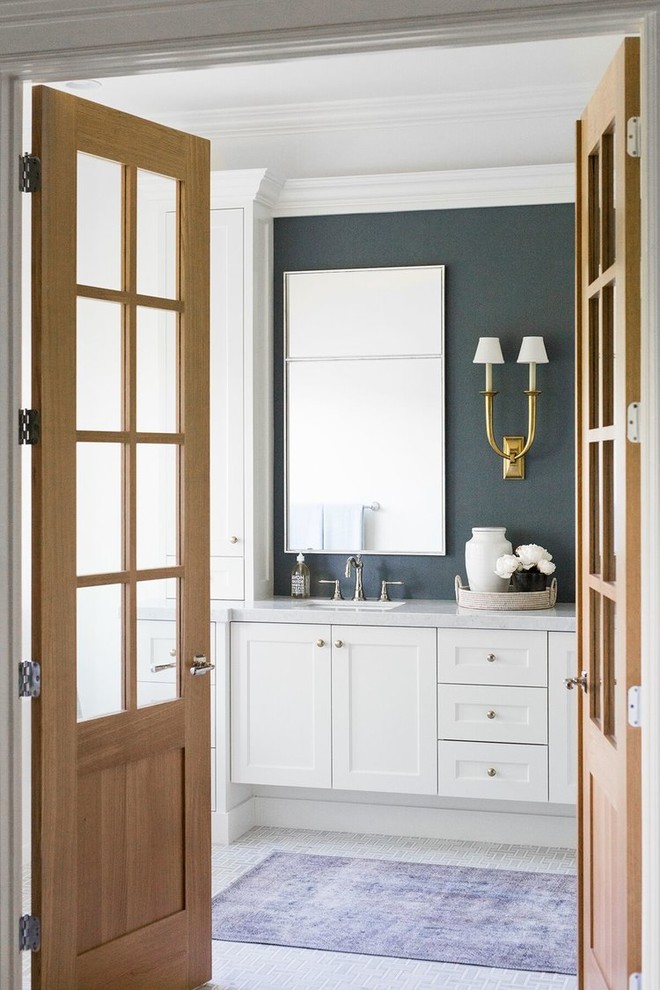 Design ideas for a large traditional ensuite bathroom in Salt Lake City with shaker cabinets, white cabinets, a freestanding bath, white tiles, blue walls, a built-in sink, white floors and grey worktops.