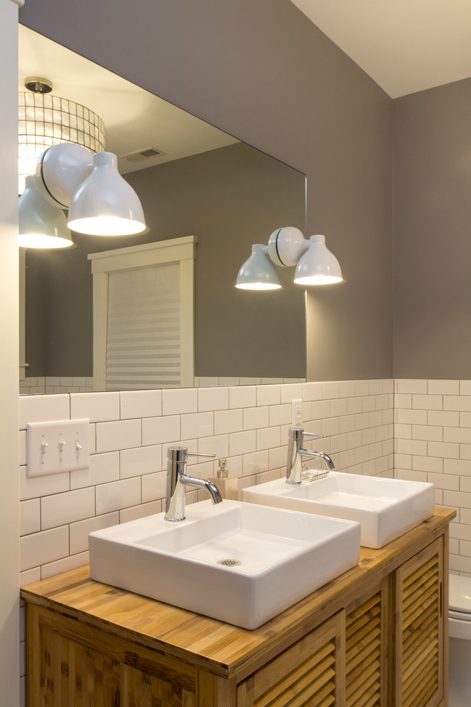 Example of a mid-sized trendy master white tile and ceramic tile ceramic tile freestanding bathtub design in Louisville with a vessel sink, louvered cabinets, light wood cabinets, wood countertops and gray walls
