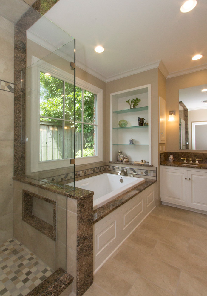 Inspiration for a medium sized traditional ensuite bathroom in New Orleans with a submerged sink, raised-panel cabinets, white cabinets, granite worktops, a built-in bath, a corner shower, a two-piece toilet, beige tiles, porcelain tiles, beige walls and porcelain flooring.