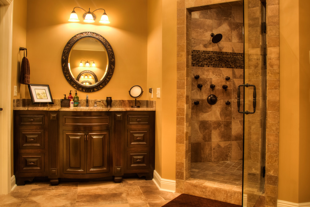 Large elegant master brown tile and mosaic tile porcelain tile bathroom photo in Other with furniture-like cabinets, dark wood cabinets, marble countertops, a two-piece toilet, an undermount sink and brown walls