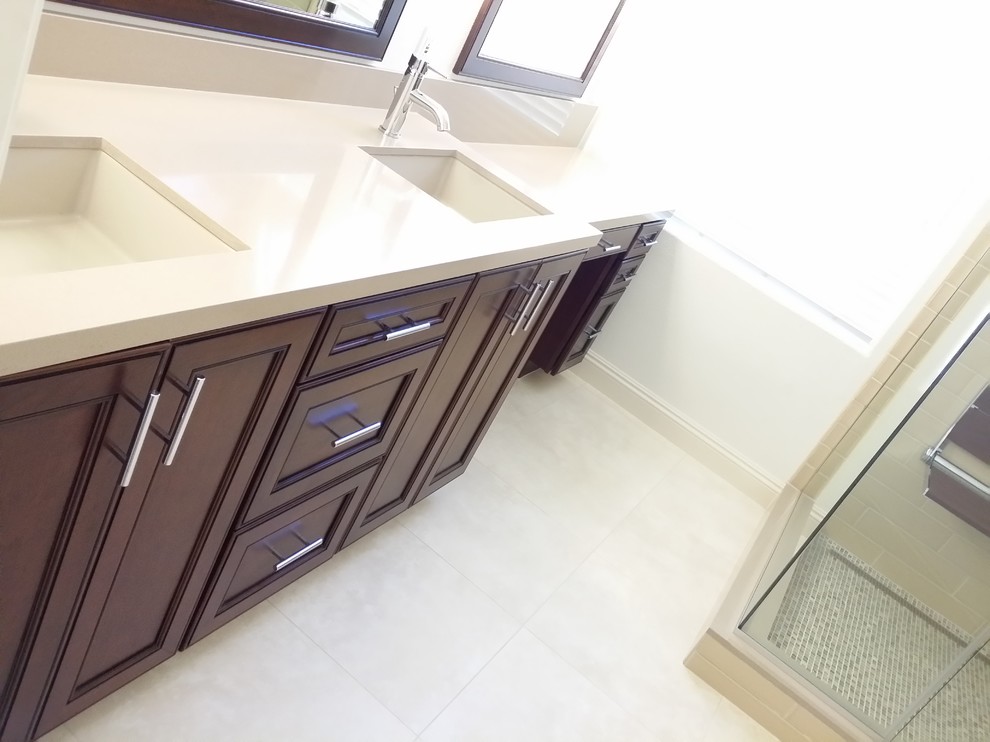 Inspiration for a mid-sized transitional master beige tile and subway tile porcelain tile corner shower remodel in Las Vegas with an undermount sink, flat-panel cabinets, dark wood cabinets, quartz countertops, a two-piece toilet and gray walls
