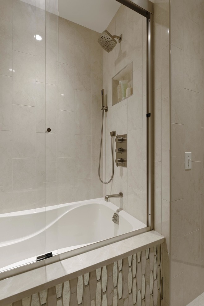 Example of a mid-sized transitional master white tile and porcelain tile porcelain tile and white floor bathroom design in DC Metro with shaker cabinets, dark wood cabinets, a wall-mount toilet, beige walls, an undermount sink, marble countertops and an undermount tub
