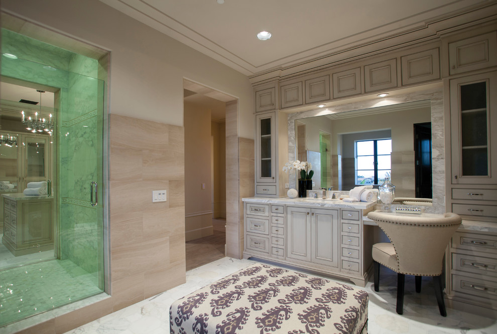 Photo of a mediterranean bathroom in Orange County with beaded cabinets, beige cabinets, an alcove shower and beige tiles.