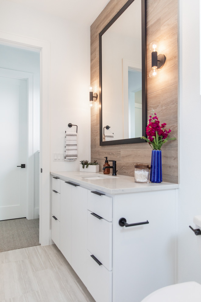 Medium sized modern family bathroom in Austin with a built-in bath, a shower/bath combination, a two-piece toilet, brown tiles, porcelain tiles, brown walls, ceramic flooring, a built-in sink, granite worktops, grey floors, a shower curtain and white worktops.