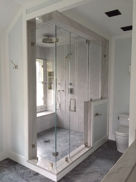 Photo of a medium sized nautical ensuite bathroom in New York with beaded cabinets, white cabinets, a freestanding bath, a corner shower, a one-piece toilet, grey tiles, porcelain tiles, grey walls, slate flooring, a submerged sink, quartz worktops, grey floors and a hinged door.