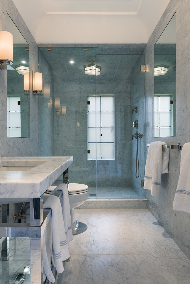 This is an example of a large traditional bathroom in Philadelphia with a submerged sink, marble worktops, an alcove shower, a two-piece toilet, grey tiles, stone tiles and marble flooring.