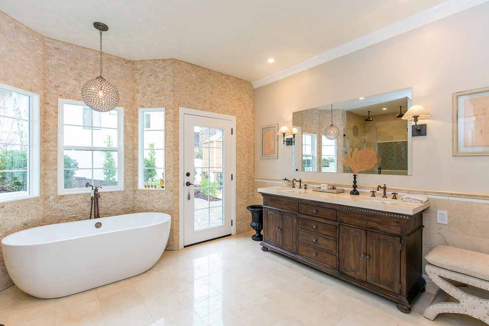 Mid-sized trendy master beige tile and stone tile marble floor bathroom photo in Los Angeles with beaded inset cabinets, dark wood cabinets, a two-piece toilet, beige walls, an undermount sink and marble countertops