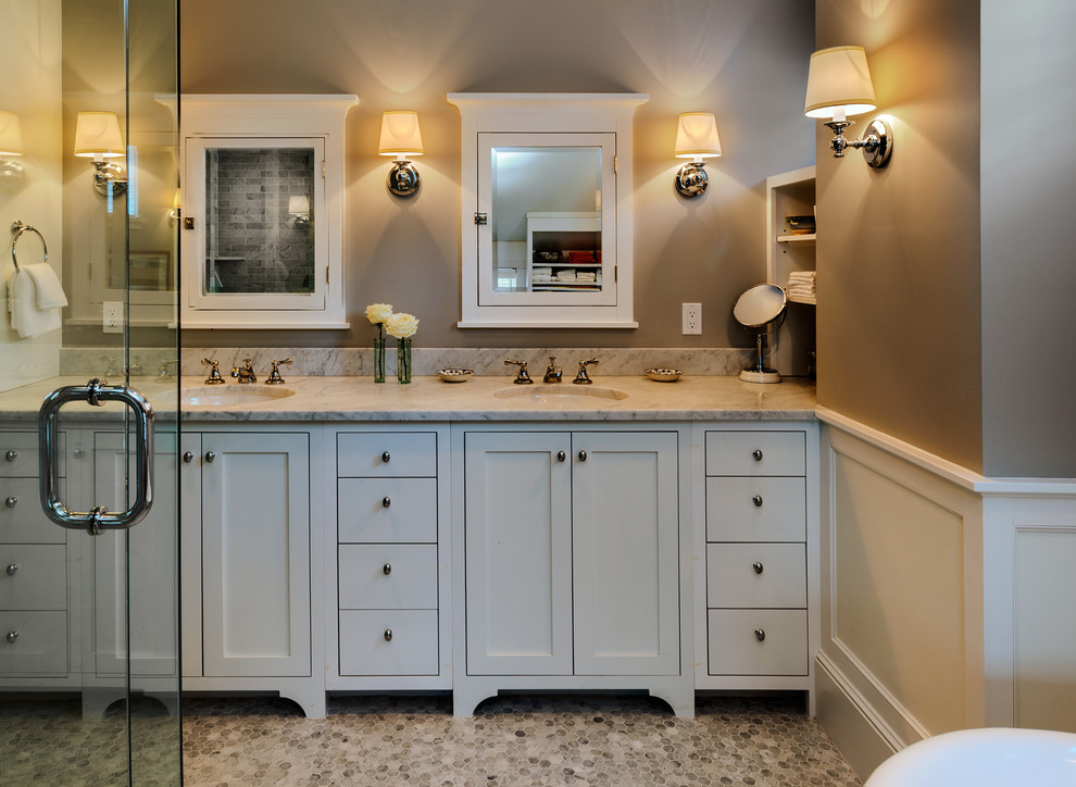 Beach style bathroom in Portland Maine with white cabinets.