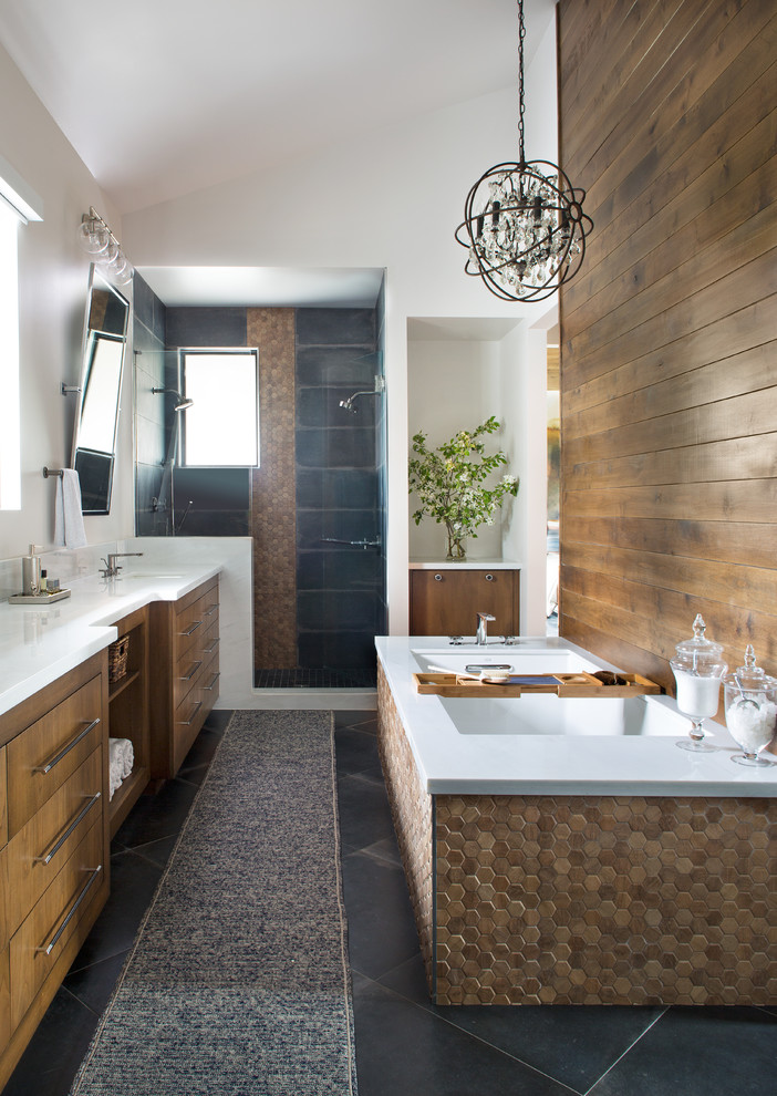 Large eclectic master slate floor and gray floor bathroom photo in Denver with flat-panel cabinets, medium tone wood cabinets, white walls, a drop-in sink, solid surface countertops, a hinged shower door and white countertops