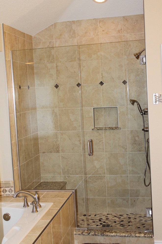 Photo of a classic bathroom in Denver with a submerged sink, flat-panel cabinets, dark wood cabinets, granite worktops, a built-in bath, a walk-in shower, a two-piece toilet, beige tiles and porcelain tiles.