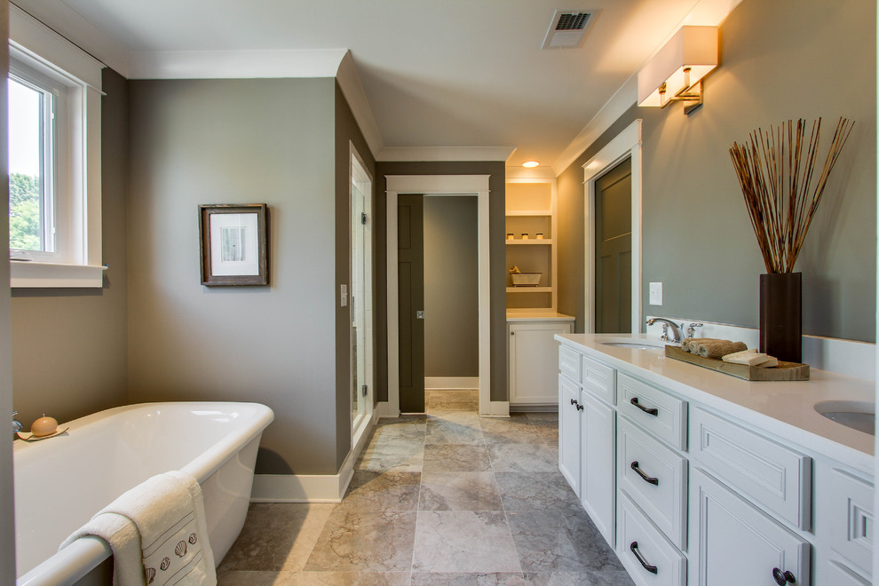 Bathroom - mid-sized transitional master gray tile and stone tile marble floor bathroom idea in Nashville with an undermount sink, recessed-panel cabinets, white cabinets, quartz countertops, a two-piece toilet and gray walls