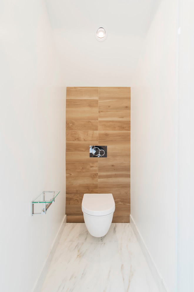 Photo of a large contemporary cloakroom in San Francisco with flat-panel cabinets, dark wood cabinets, a wall mounted toilet, brown tiles, porcelain tiles, white walls, marble flooring, a vessel sink, engineered stone worktops and white floors.