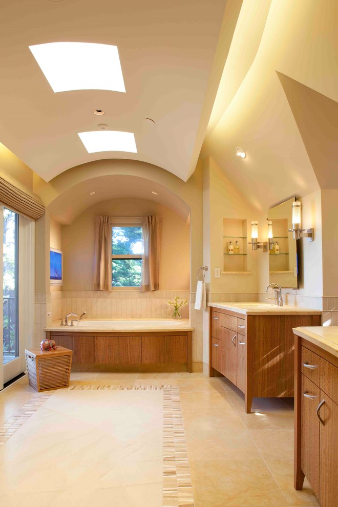 Inspiration för mellanstora medelhavsstil en-suite badrum, med ett konsol handfat, skåp i mellenmörkt trä, ett platsbyggt badkar och beige väggar