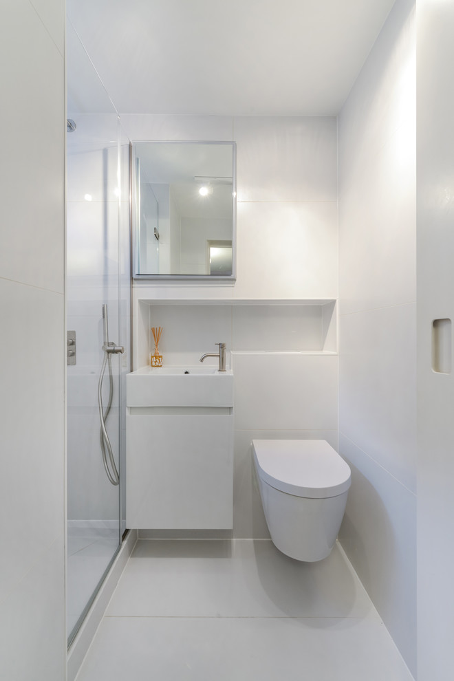 Inspiration for a contemporary 3/4 white floor bathroom remodel in London with flat-panel cabinets, white cabinets, white walls and a console sink