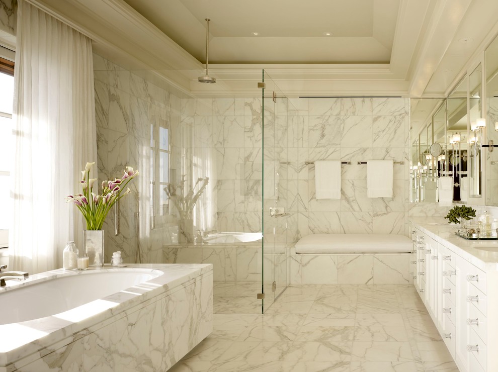 Exemple d'une salle de bain chic avec un lavabo encastré, un placard à porte plane, des portes de placard blanches, une baignoire encastrée, une douche à l'italienne, un carrelage blanc, un mur blanc et une fenêtre.